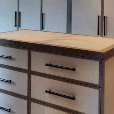 Primary Dressing Room Wooden dresser with six drawers, minimalist design, and black handles.