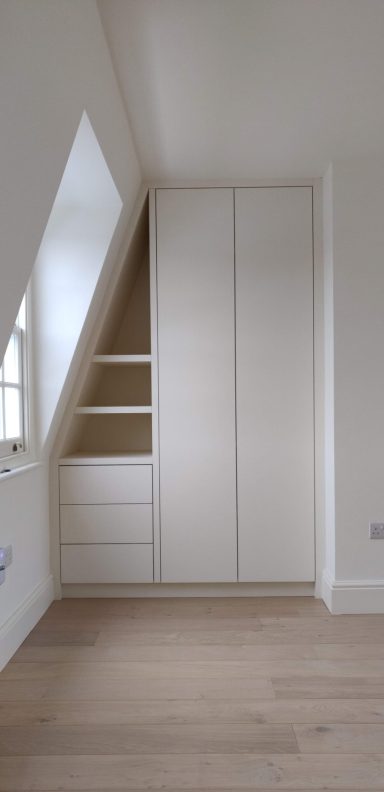 Porcelain White loft wardrobe with drawers Modern white wardrobe with slanted design and open shelving in a minimalist room.